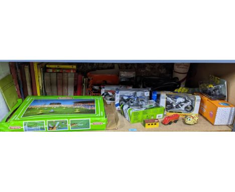 A mixed lot of toys and books to include a boxed Subbuteo game, boxed die model motor bikes, tinplate clockwork shopping dog,