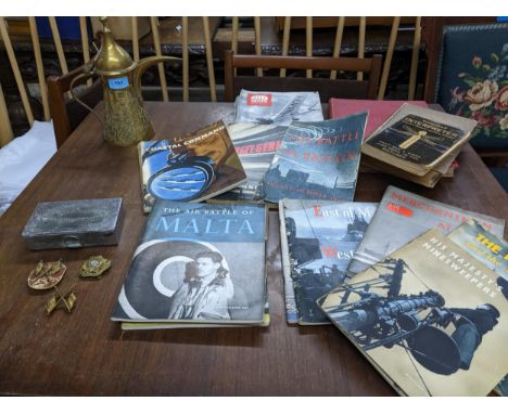 A selection of items of military interest to include three WWII cap badges and a mess tin, a Saudi Arabian brass dallah coffe