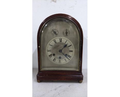 An Edwardian mahogany arched top 8 day mantle clock having subsidiary regulation dial and chime/silent striking on five rods 
