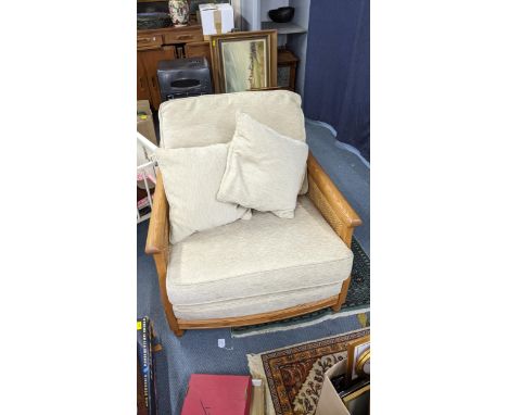 A modern Ercol oak framed Bergère armchair with carved sides Location:A3B 