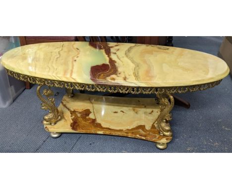 A vintage only two tier coffee table having gilt metal dolphins shaped supports 46hx117wLocation: 