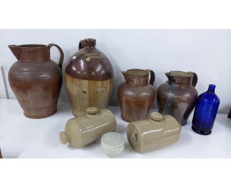 A mixed lot to include a Jones & Rye Witney salt glazed flagon, two footwarmer, a Chiltern Hills water bottle and three Frenc