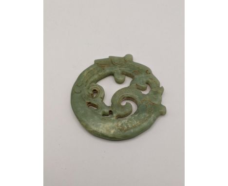 A jade double sided carved disc fashioned as a dragon, Location: 