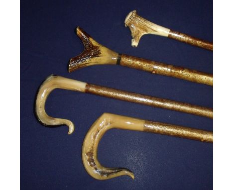 Group of four assorted shepherds style walking sticks, with two traditional rams horn handles, another antler thumb stick and