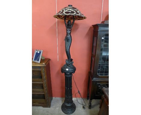 An Art Nouveau style lamp on pedestal
