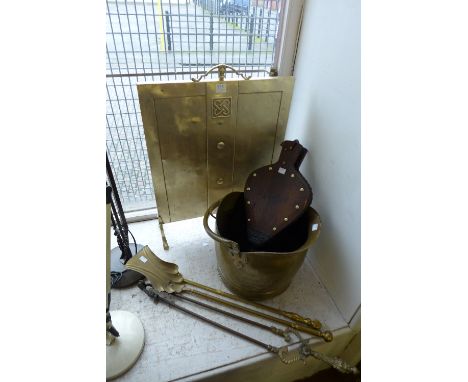 An Arts and Crafts fire screen, coal bucket, andirons and fire bellows