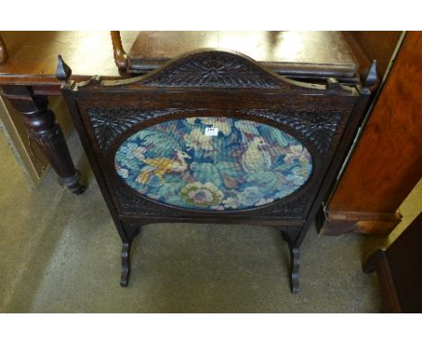 An Edward VII oak and embroidered firescreen
