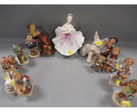 A selection of Goebel figures to include a gloss finish bear cub together with a Royal Doulton figurine etc 
