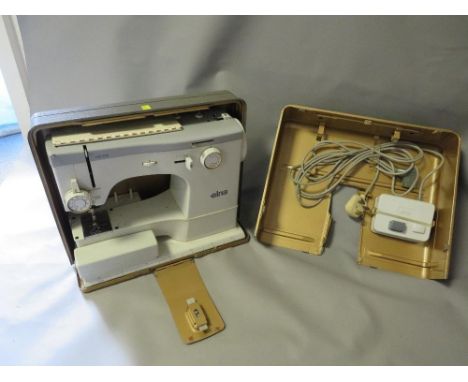 A cased vintage sewing machine 
