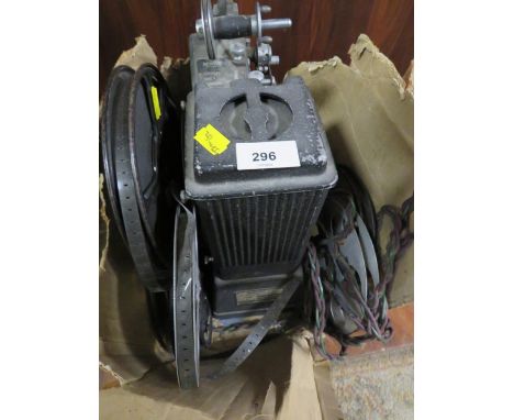 A vintage Specto film projector with manual and various reels of film 