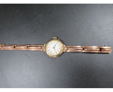 A vintage 9 carat gold watch on expanded plated bracelet 