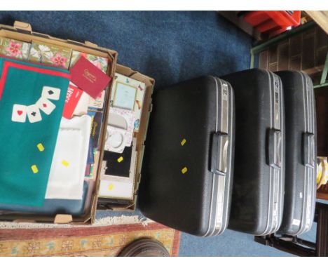 Three graduating vintage suitcases together with a tray of photo frames and a tray of sundries 