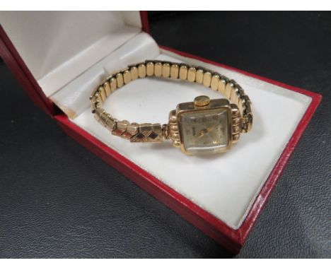 A 9 carat gold rotary wrist watch on a 9 carat gold expandable bracelet 