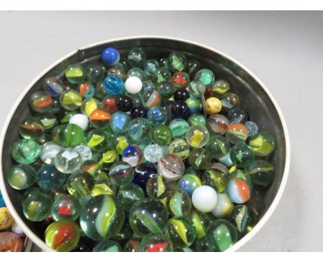 A tin and bag of vintage marbles 