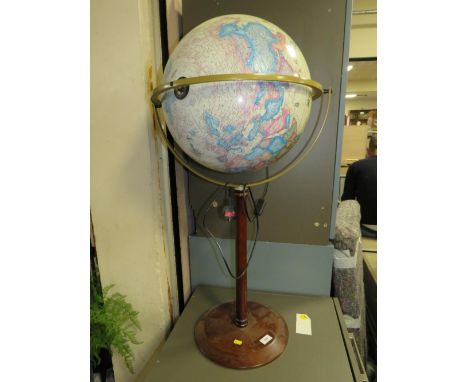 A modern illuminating globe on stand 