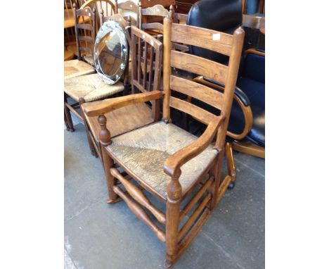 AN ASH LADDER BACK AND RUSH SEATED ROCKING CHAIR