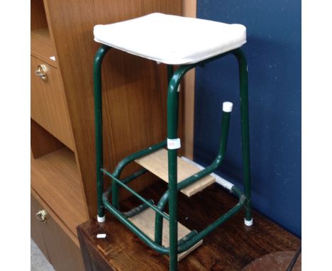 A GREEN METAL STEP STOOL