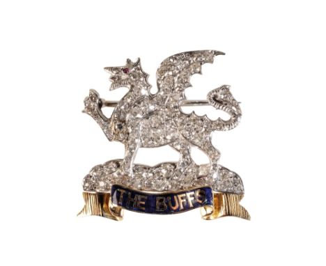 REGIMENTAL DIAMOND BROOCH, in the form of dragon, above an unmarked yellow metal scroll, stamped "THE BUFFS", on a blue ename