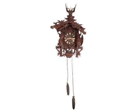 BLACK FOREST CUCKOO CLOCK, the wooden dial with Roman numerals, the German movement striking on a coiled gong, the case decor