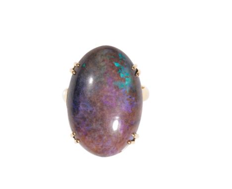 A BLACK OPAL DRESS RING, with green &amp; blue hues, approx 24mm x 15mm, raised claw-set, on a yellow gold shank, with ball s