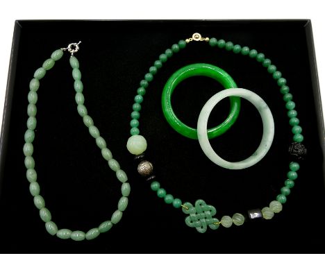 Two jade bangles, jade and cinabar necklace and a celadon jade necklace - Condition Report