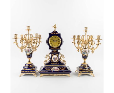 A three-piece porcelain mantle garniture clock and candelabra, made of blue porcelain and marked Alfa, Italy. Quartz movement