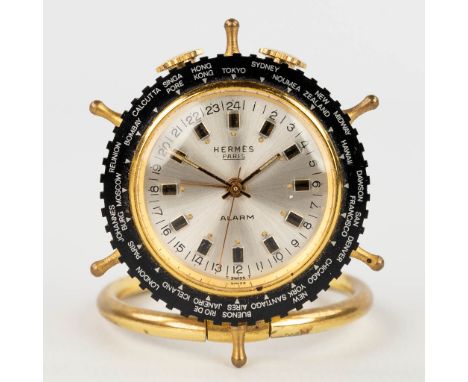 Herms, a vintage world travel alarm clock in the shape of a ship's wheel. Marked and with the orignal box. Alarm and clock in