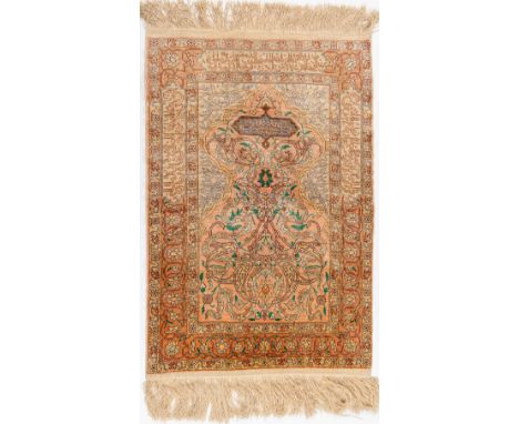An Oriental hand-made carpet, silk, Hereke. Dimensions: (L: 95 x W: 63 cm)