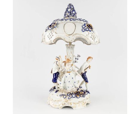 A porcelain table lamp with lithophane images and dancing figurines. Marked PMP and made in Plaue, Germany. 20th century. Dim