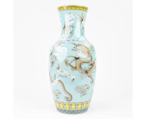 A Chinese vase made of porcelain and decorated with Dragons in a light blue color. Marked Yong Qing Chang Chun. 20th centruy.