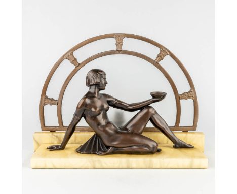 A figurative table lamp with nude female in art deco style. Spelter standing on a marble base. Circa 1920. Dimensions: (L: 17