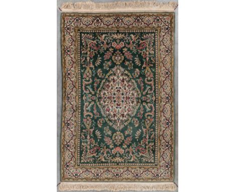 An Oriental hand-made carpet, Tabriz. Dimensions: (L: 205 x W: 135 cm)