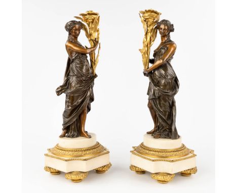 A pair of neoclassical statues of Greek/Roman figurines, made of gilt and patinated bronze on a white Carrara marble base. 19