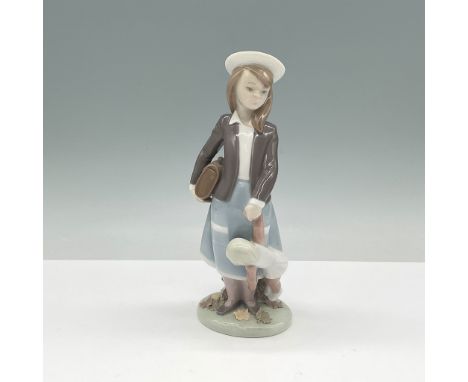 This charming Lladro porcelain figurine, Autumn model number 01005218, was produced from 1983 to 1999. It depicts a young gir