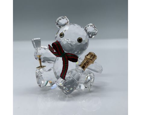 Swarovski Crystal figurine featuring Kris Bear celebrating with a champagne toast. This charming design includes intricate fa