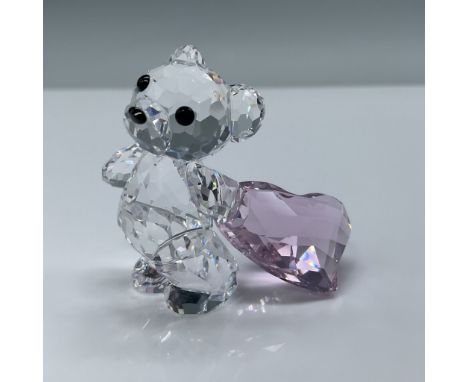 Swarovski Crystal Kris Bear figurine holding a pink faceted crystal heart. This adorable piece showcases the craftsmanship an