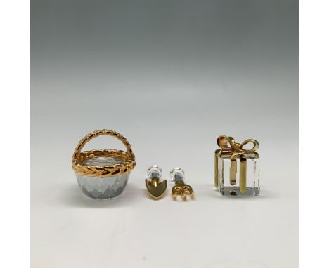 This elegant collection from Swarovski's Crystal Memories includes a "Present Gold" figurine (191603) and the "Gardening Set 