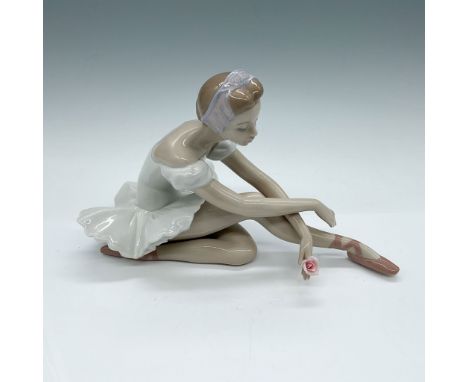 Elegant Lladro porcelain figurine titled Rose Ballet, depicting a seated ballerina in a delicate pose, with a pink rose accen