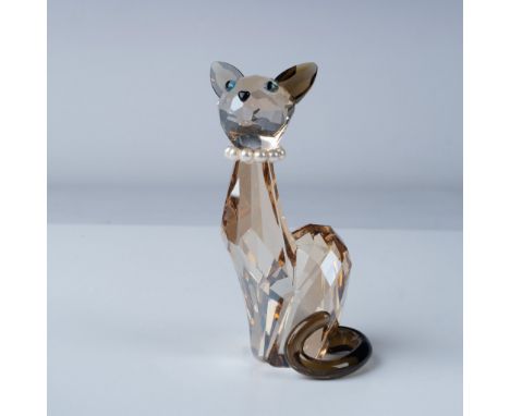 This exquisite Swarovski crystal figurine features a beautifully crafted amber-colored cat, showcasing the brand's signature 