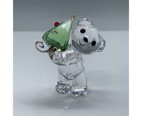 This delightful Swarovski Crystal Kris Bear figurine features a playful bear holding a green crystal Christmas tree adorned w