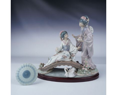 Lladro figurine 01001445, titled Springtime in Japan, depicts a serene scene of two elegantly dressed geishas on a bridge, co