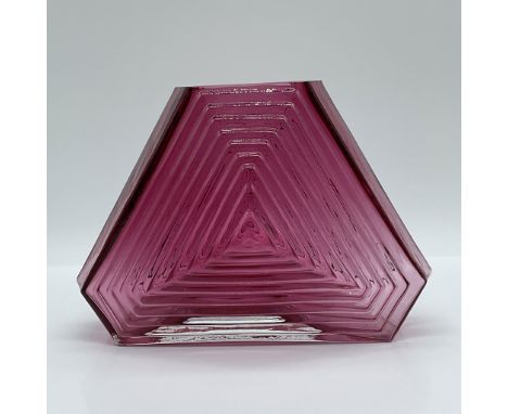 This striking Art Deco vase features a bold geometric ribbed design, crafted from vibrant cranberry glass. The tapered hexago