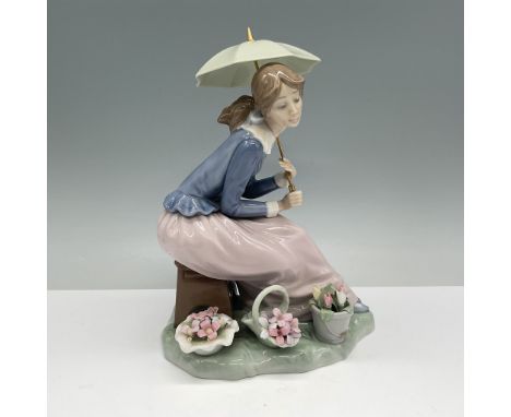 Charming Nao by Lladro porcelain figurine featuring a seated young woman holding a pastel green umbrella, dressed in a flowin