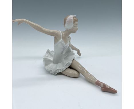 Lladro porcelain figurine titled "Swan Ballet". This stunning piece depicts a graceful ballerina in a stretching pose, meticu