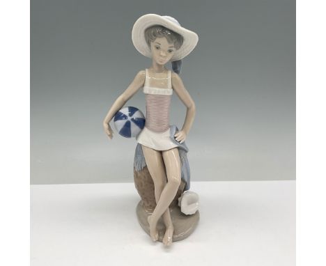 Charming Lladro porcelain figurine titled Summer, model number 01005219. Depicts a young girl in a relaxed pose, sitting with
