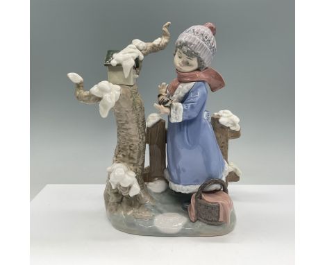 This beautifully detailed Lladro porcelain figurine, titled Winter Frost, depicts a young girl in a winter setting. Dressed i