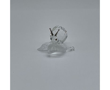 A charming addition to the Swarovski "Among Flowers and Foliage" series, this finely crafted crystal figurine features a snai