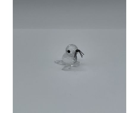 This exquisite Swarovski Crystal figurine, model number 012530, beautifully captures the grace of a seal with intricate detai
