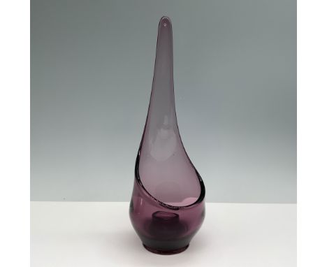 This captivating vintage purple glass candleholder features a unique tear drop shape, with a slender neck leading to a rounde