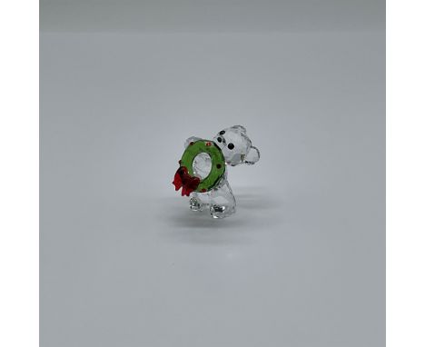 This delightful Swarovski Kris Bear  5286159 brings festive cheer to your home with its clear, green, red, and black crystal 